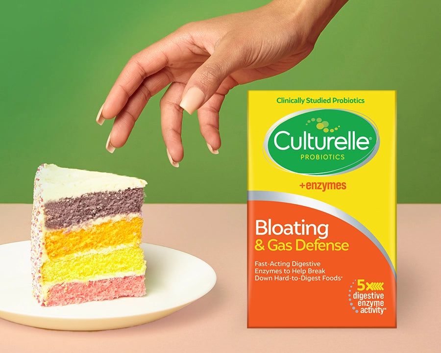 Probiotics for bloating and gas next to a piece of cake